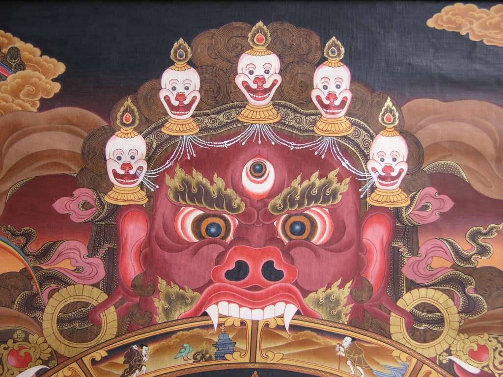 Tibetan Buddhism Wheel Of Life 03 Yama Yama, the Lord of Death, holds the wheel in his mouth and embraces it with his claws, symbolizing the inevitability of death, samsara and the impermanence of all things. Yama has a horrific face with projecting fangs and a forehead wreathed in the macabre five-skull crown.